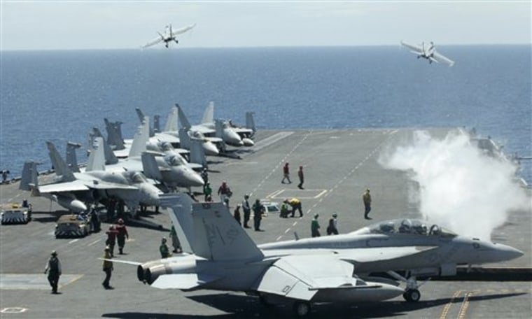 U.S. fighters take off from the flight deck of the Nimitz-class USS George Washington for joint military exercises between the U.S. and South Korea in South Korea's East Sea on Monday, July 26.
